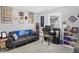 Cozy living room with a sofa, desk, display shelves, and carpeted floor at 400 E Charter Dr, Muncie, IN 47303