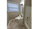Well-lit bathroom with white fixtures, a tub-shower combo, and updated hardware at 4120 Breton St, Indianapolis, IN 46222