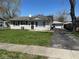 Charming single-story home with vinyl siding, a well-kept lawn, and a detached two-car garage at 4120 Breton St, Indianapolis, IN 46222