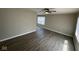 Open living area with wood-look floors, a ceiling fan, and ample natural light at 4120 Breton St, Indianapolis, IN 46222