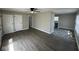 Spacious living room featuring modern flooring, a ceiling fan, and a convenient closet at 4120 Breton St, Indianapolis, IN 46222