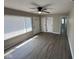 Bright living room featuring wood-look floors, a ceiling fan, and a large window at 4120 Breton St, Indianapolis, IN 46222