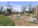 Relaxing backyard featuring a stone fire pit area with Adirondack chairs and a wooden deck, ideal for gatherings at 413 Vasbinder Dr, Anderson, IN 46017