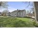 Well-maintained single-story home with a green lawn and mature trees in a residential neighborhood at 413 Vasbinder Dr, Anderson, IN 46017