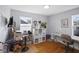 Functional home office with a desk, chair, storage units, and natural light from two windows at 413 Vasbinder Dr, Anderson, IN 46017