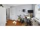 Well-lit office with hardwood floors, dual monitors, open doorway and a stylish chair at 413 Vasbinder Dr, Anderson, IN 46017