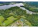 Expansive aerial view of a residential area surrounded by lush green trees and a large lake at 4707 Branch View Way, Indianapolis, IN 46234