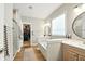 Well-appointed bathroom featuring a tub, walk-in closet, and modern fixtures at 4707 Branch View Way, Indianapolis, IN 46234