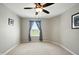 Neutral bedroom featuring a ceiling fan, neutral walls and a window with blue curtains at 4707 Branch View Way, Indianapolis, IN 46234