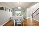 Elegant dining room featuring a large window, a dining table with chairs, and hardwood floors at 4707 Branch View Way, Indianapolis, IN 46234