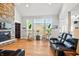 Bright living room with a stone fireplace, hardwood floors, and large windows at 4707 Branch View Way, Indianapolis, IN 46234