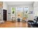 Sun-filled living room with hardwood floors, neutral walls, and views of the surrounding greenery at 4707 Branch View Way, Indianapolis, IN 46234