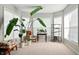 Bright sitting area with large windows and plants and features a comfortable chair, side table, and decor at 4707 Branch View Way, Indianapolis, IN 46234