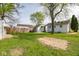 Expansive backyard featuring a well-maintained lawn, a detached garage, and a wooden fence for added privacy at 4814 Southeastern Ave, Indianapolis, IN 46203