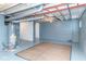 Unfinished basement offering ample space with concrete floor, visible pipes and a hot water heater at 4814 Southeastern Ave, Indianapolis, IN 46203