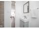 Stylish bathroom with a modern vanity, mirror, and a view into an adjoining living area at 4814 Southeastern Ave, Indianapolis, IN 46203