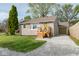 Charming single-story home featuring stone siding, a gravel driveway, and a well-maintained front lawn at 4814 Southeastern Ave, Indianapolis, IN 46203