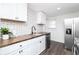 Bright, updated kitchen featuring white cabinets, a tile backsplash, and stainless steel appliances at 4814 Southeastern Ave, Indianapolis, IN 46203