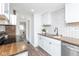 Well-lit kitchen with white cabinets, stainless steel appliances, and wood countertops at 4814 Southeastern Ave, Indianapolis, IN 46203