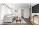 Bright living room featuring a comfortable gray sofa, modern decor, and hardwood floors at 4814 Southeastern Ave, Indianapolis, IN 46203