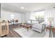 Open-concept living room featuring bright natural light, modern furniture, and minimalist decor at 4814 Southeastern Ave, Indianapolis, IN 46203