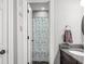 Bathroom view showcases colorful shower curtain and modern sink with gray granite countertop at 4955 N 500 W, Columbus, IN 47201