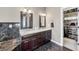 Bathroom with granite countertop, dual sinks, dark wood cabinets, and closet with shelving at 4955 N 500 W, Columbus, IN 47201