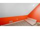 Bedroom features a sloped ceiling, orange accent wall, and carpeted floor at 4955 N 500 W, Columbus, IN 47201
