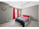 Bedroom features neutral walls, red curtains, ceiling fan, and carpeted floor at 4955 N 500 W, Columbus, IN 47201