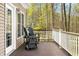 Inviting deck with rocking chairs, wood floors, and scenic views of the surrounding nature at 4955 N 500 W, Columbus, IN 47201
