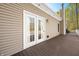 Inviting deck with wood floors and scenic views of the surrounding nature seen through french doors at 4955 N 500 W, Columbus, IN 47201