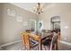 Cozy dining room with a wooden table set for six and views of the surrounding landscape at 4955 N 500 W, Columbus, IN 47201