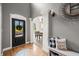 Welcoming entryway with hardwood floors, decorative door, and view into adjacent dining area at 4955 N 500 W, Columbus, IN 47201