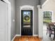 Welcoming entryway with hardwood floors, decorative door, and view into adjacent dining area at 4955 N 500 W, Columbus, IN 47201