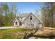Two-story home with horizontal siding and a manicured lawn, sitting on a wooded lot at 4955 N 500 W, Columbus, IN 47201