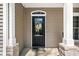 A close up of the front door with a glass window and wreath with a black mat at 4955 N 500 W, Columbus, IN 47201