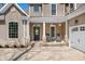 Inviting front porch featuring stone supports, a front door with wreath and two chairs at 4955 N 500 W, Columbus, IN 47201