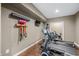 Exercise room featuring modern treadmill, stationary bike, and wall-mounted storage for accessories at 4955 N 500 W, Columbus, IN 47201