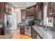 A well-appointed kitchen showcases stone backsplash, stainless appliances and granite countertops at 4955 N 500 W, Columbus, IN 47201