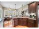 Open kitchen and dining area with hardwood floors, granite countertops, and stainless appliances at 4955 N 500 W, Columbus, IN 47201