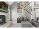Cozy living room with stone fireplace, plush seating, and a staircase leading to the upper level at 4955 N 500 W, Columbus, IN 47201