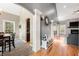 Open-concept living space with hardwood floors, stone fireplace, and seamless flow to dining and kitchen areas at 4955 N 500 W, Columbus, IN 47201