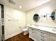 Modern bathroom featuring a white vanity with marble countertop and dark wood-look tile flooring at 5135 N Kenwood Ave, Indianapolis, IN 46208