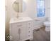 Clean bathroom with white vanity, sink, stylish gold hardware, and a round mirror at 5135 N Kenwood Ave, Indianapolis, IN 46208