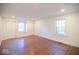 Spacious bedroom with hardwood flooring, two closets, and a bright window offering natural light at 5135 N Kenwood Ave, Indianapolis, IN 46208