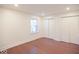 Bright bedroom with hardwood floors, a window for natural light, and two closets for storage at 5135 N Kenwood Ave, Indianapolis, IN 46208