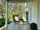 Inviting front porch with comfortable seating and beautiful views of the landscaped front yard at 5135 N Kenwood Ave, Indianapolis, IN 46208