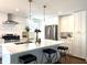 Bright, remodeled kitchen with a large center island, stainless steel appliances and modern lighting at 5135 N Kenwood Ave, Indianapolis, IN 46208
