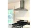 Modern kitchen, featuring gas cooktop, stainless steel appliances, and white subway tile backsplash at 5135 N Kenwood Ave, Indianapolis, IN 46208