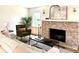 Cozy living room featuring a brick fireplace, comfortable seating, and stylish decor at 5135 N Kenwood Ave, Indianapolis, IN 46208